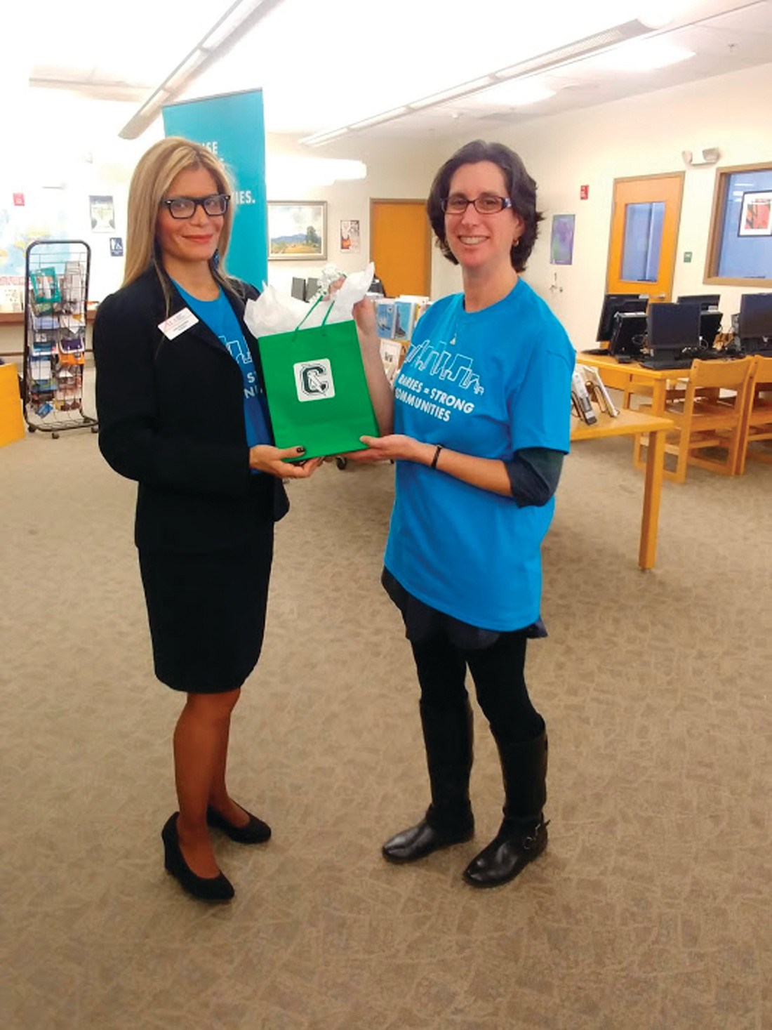 A TOKEN OF APPRECIATION: Cranston High School East librarian Heidi Blais presents Garcia-Febo with a token gift from the Thunderbolts.